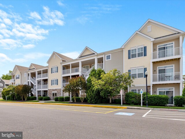 20005 Newry Dr Unit Y13, Rehoboth Beach, DE 19971 - view of building exterior featuring uncovered parking