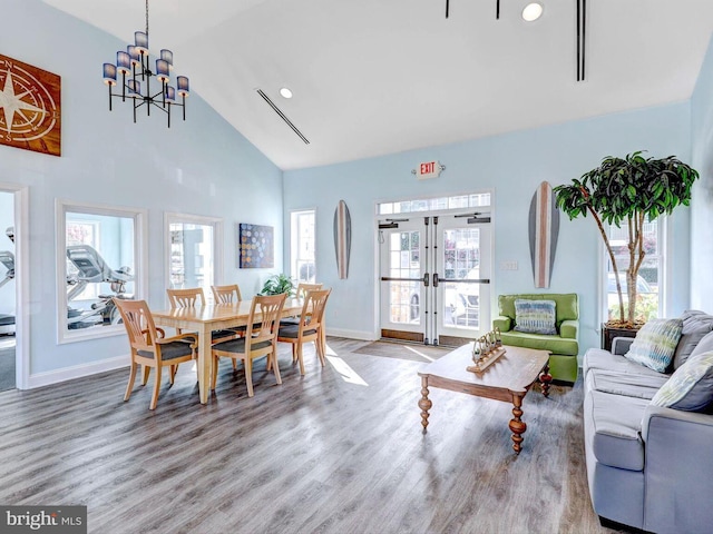 20005 Newry Dr Unit Y13, Rehoboth Beach, DE 19971 - dining area with french doors, a chandelier, healthy amount of natural light, wood finished floors, and high vaulted ceiling