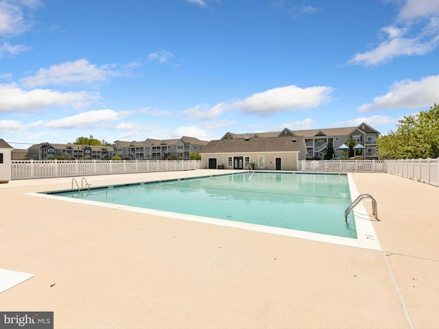 20005 Newry Dr Unit Y13, Rehoboth Beach, DE 19971 - community pool featuring a residential view and a patio area