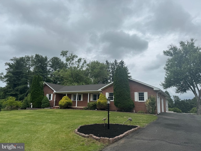 1404 Stockton Rd, Joppa, MD 21085 - ranch-style house with brick siding, a garage, driveway, and a front yard
