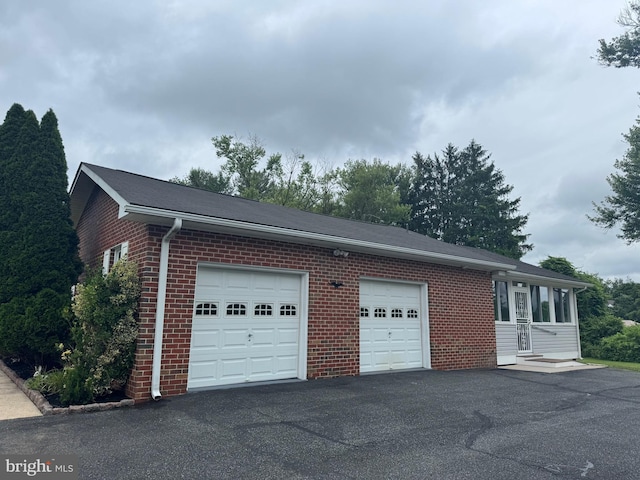 1404 Stockton Rd, Joppa, MD 21085 - view of side of home with brick siding, asphalt driveway, and an attached garage