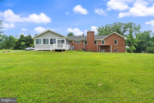 1404 Stockton Rd, Joppa, MD 21085 - back of property featuring a sunroom, a chimney, and a lawn