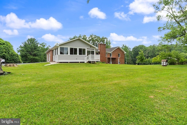 1404 Stockton Rd, Joppa, MD 21085 - rear view of house featuring a sunroom, a chimney, a lawn, and a shed