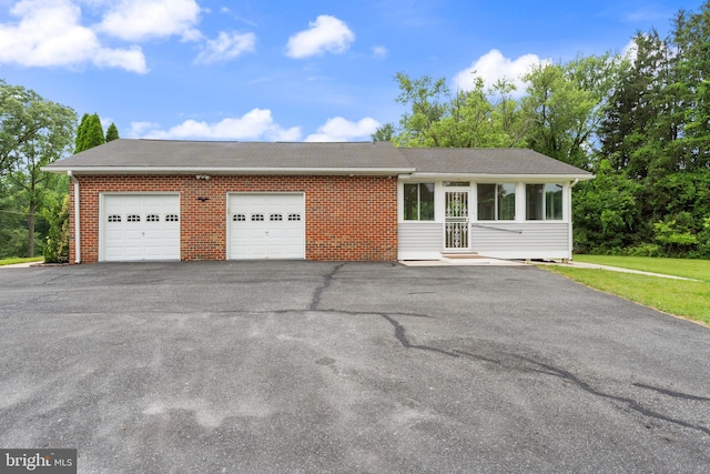 1404 Stockton Rd, Joppa, MD 21085 - single story home featuring driveway, an attached garage, roof with shingles, brick siding, and a sunroom