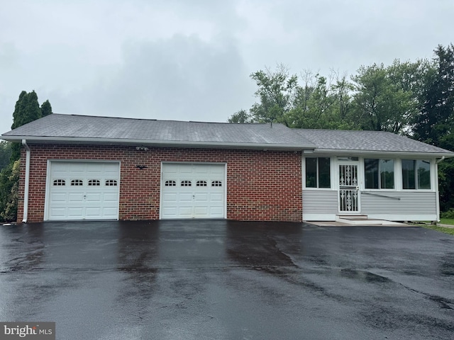 1404 Stockton Rd, Joppa, MD 21085 - view of home's exterior featuring driveway, a garage, a shingled roof, and entry steps