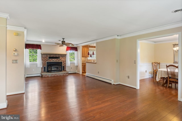 1404 Stockton Rd, Joppa, MD 21085 - unfurnished living room featuring a baseboard heating unit, a ceiling fan, dark wood-style flooring, ornamental molding, and a wainscoted wall