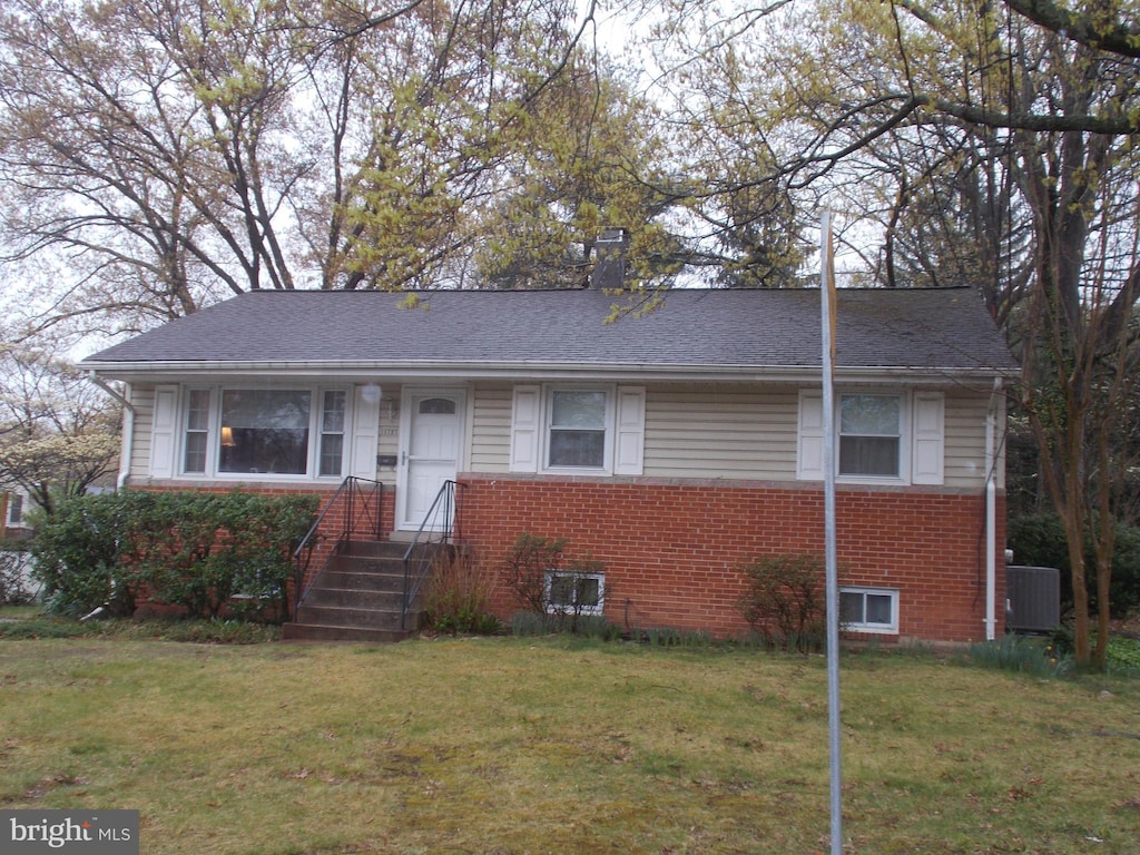 11727 Emack Rd, Beltsville, MD 20705 - view of front of house featuring brick siding, central AC unit, and a front yard