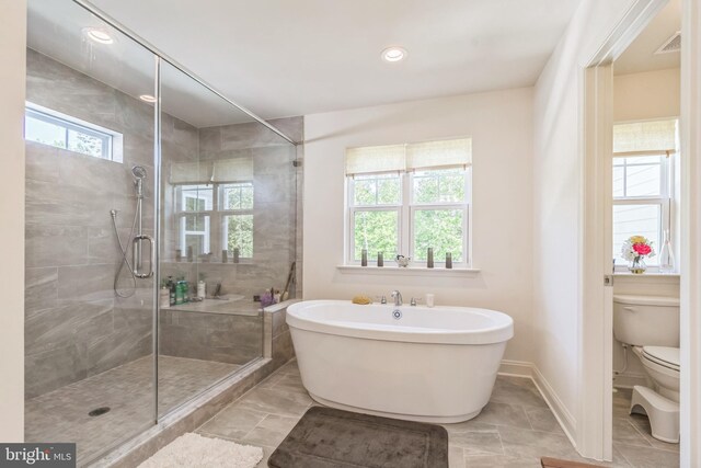 8604 Cedar Chase Dr, Clinton, MD 20735 - bathroom with toilet, a freestanding tub, a stall shower, baseboards, and recessed lighting