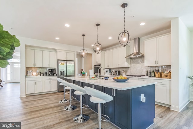 8604 Cedar Chase Dr, Clinton, MD 20735 - kitchen featuring stainless steel appliances, wall chimney exhaust hood, tasteful backsplash, white cabinetry, and recessed lighting