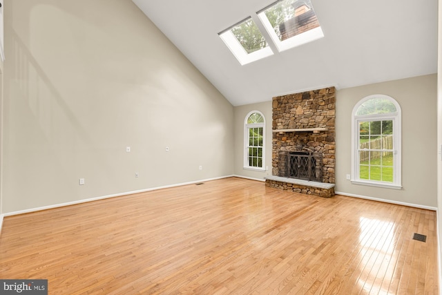 5501 Chestermill Ct, Fairfax, VA 22030 - unfurnished living room with high vaulted ceiling, a skylight, plenty of natural light, light wood finished floors, and a fireplace