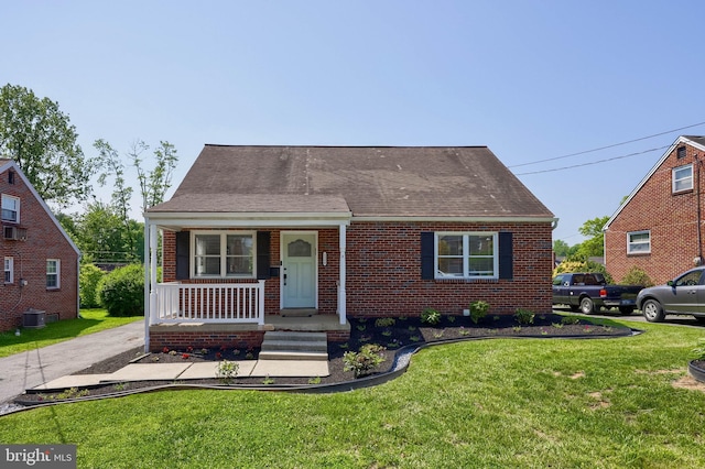 1304 Maple Ave, Lancaster, PA 17603 - view of front of property with a porch, a front yard, brick siding, and central air condition unit