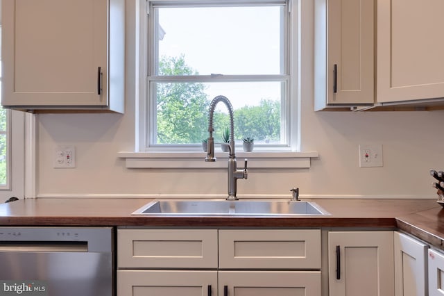 1304 Maple Ave, Lancaster, PA 17603 - kitchen with stainless steel dishwasher, a sink, and wooden counters