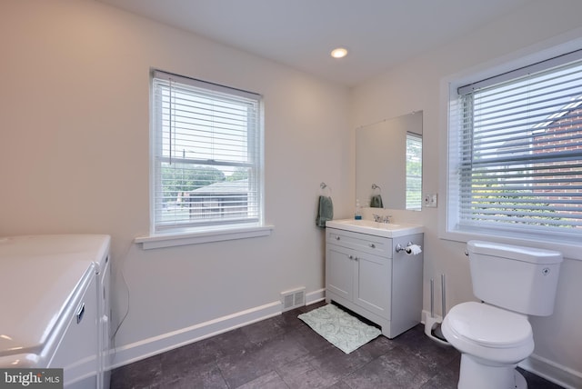 1304 Maple Ave, Lancaster, PA 17603 - bathroom with washer and clothes dryer, vanity, baseboards, and toilet