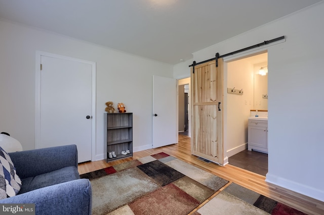 1304 Maple Ave, Lancaster, PA 17603 - living area with wood finished floors, a barn door, and baseboards