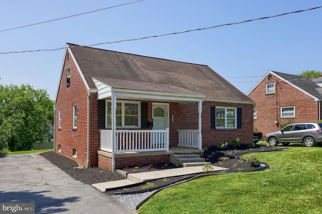 1304 Maple Ave, Lancaster, PA 17603 - view of front of property with covered porch, a front yard, and brick siding