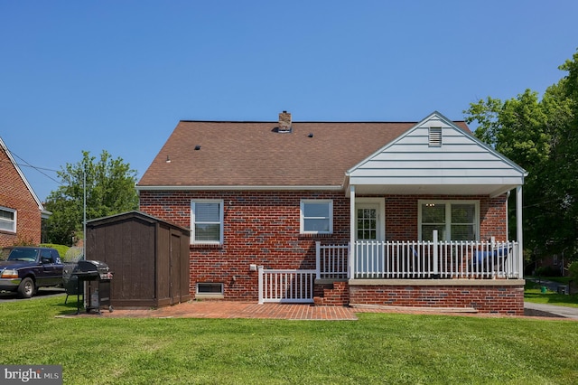 1304 Maple Ave, Lancaster, PA 17603 - back of property with brick siding, a lawn, covered porch, a chimney, and a shingled roof