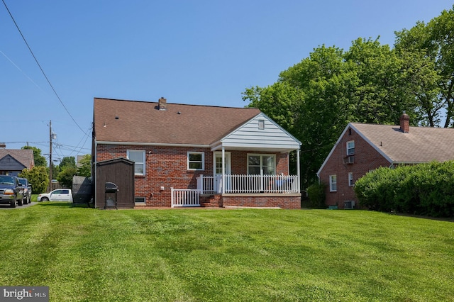 1304 Maple Ave, Lancaster, PA 17603 - rear view of property with covered porch, brick siding, a lawn, and central AC