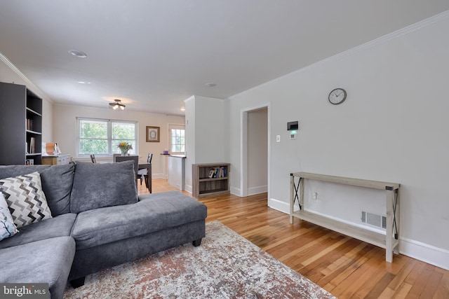 1304 Maple Ave, Lancaster, PA 17603 - living room featuring light wood-style floors, ornamental molding, and baseboards
