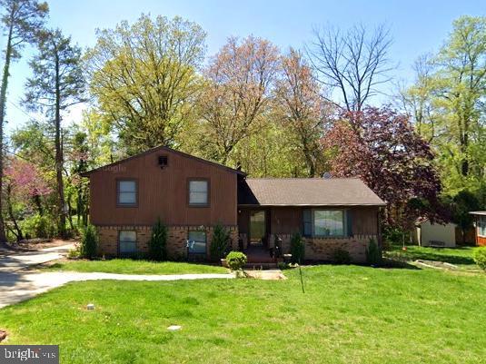 7141 Campfield, Baltimore, MD 21207 - view of front facade with a front yard and brick siding