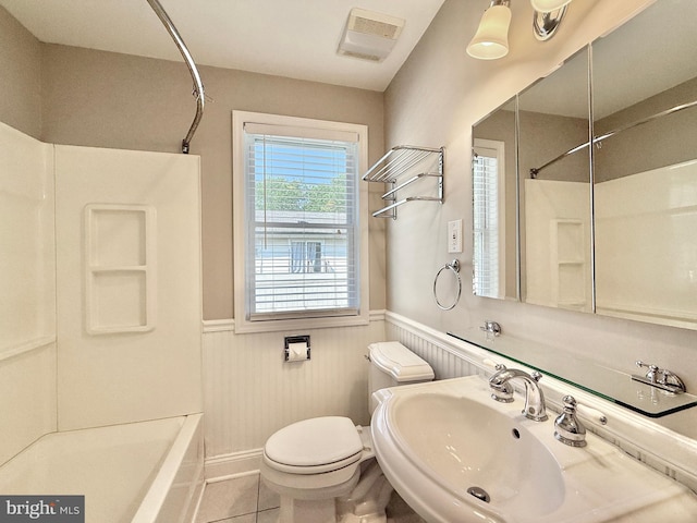 504 Redrow Ave, Swedesboro, NJ 08085 - bathroom with wainscoting, shower / bath combination, and tile patterned flooring