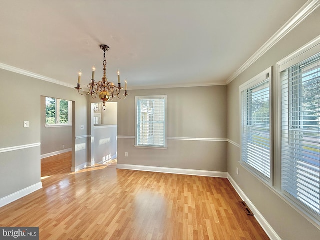 504 Redrow Ave, Swedesboro, NJ 08085 - spare room featuring a chandelier, plenty of natural light, light wood-type flooring, and crown molding