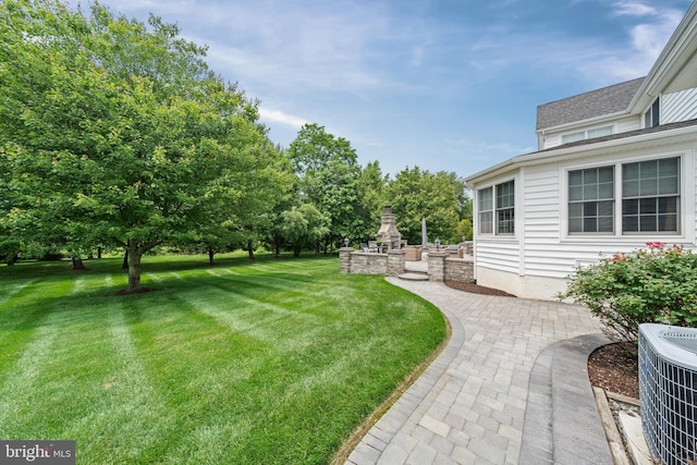 1427 Olmsted Dr, Bear, DE 19701 - view of green lawn with a fireplace and a patio