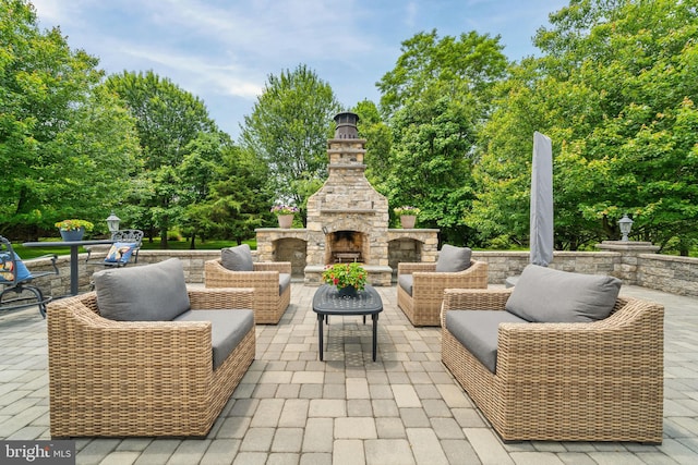1427 Olmsted Dr, Bear, DE 19701 - view of patio / terrace with an outdoor living space with a fireplace and view of wooded area
