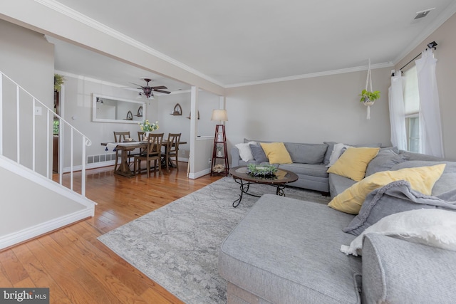621 Foxton Ct, West Deptford, NJ 08051 - living room featuring hardwood / wood-style flooring, crown molding, ceiling fan, stairs, and baseboards