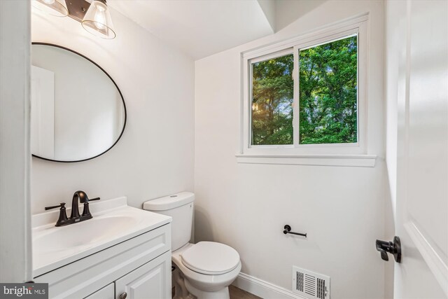 5202 Bayne Pl, Temple Hills, MD 20748 - half bathroom with vanity, toilet, and baseboards