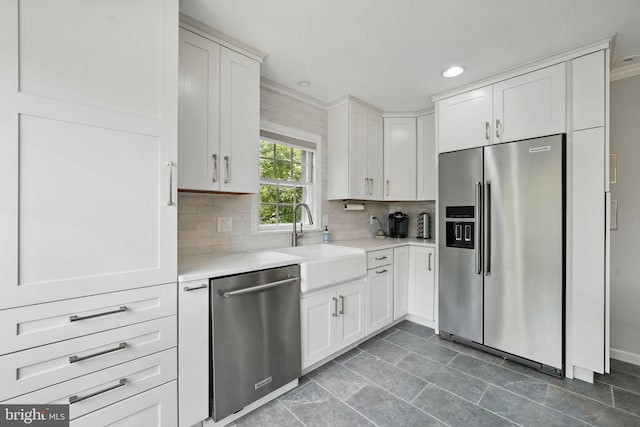 6622 Skyline Ct, Alexandria, VA 22307 - kitchen featuring appliances with stainless steel finishes, a sink, backsplash, white cabinets, and recessed lighting