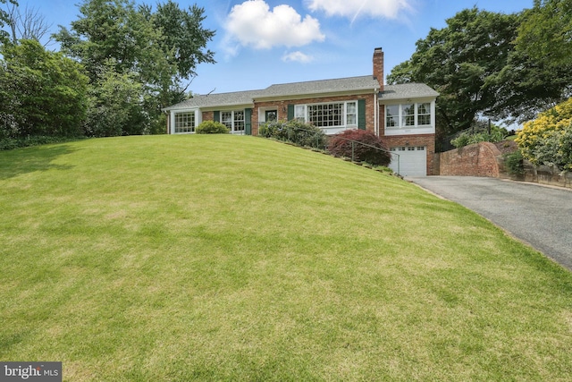 6622 Skyline Ct, Alexandria, VA 22307 - view of front of house with asphalt driveway, a chimney, brick siding, a garage, and a front lawn