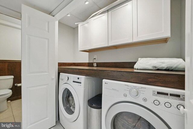 6622 Skyline Ct, Alexandria, VA 22307 - laundry room with independent washer and dryer, cabinet space, and light tile patterned floors
