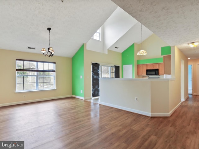6344 Springwater Ter Unit 1141, Frederick, MD 21701 - kitchen featuring black microwave, a textured ceiling, high vaulted ceiling, wood finished floors, and a chandelier