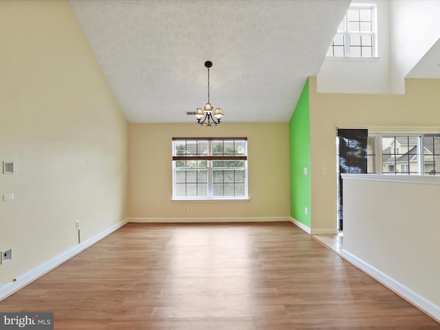 6344 Springwater Ter Unit 1141, Frederick, MD 21701 - unfurnished dining area with a chandelier, plenty of natural light, wood finished floors, and vaulted ceiling
