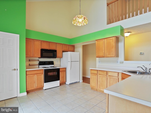 6344 Springwater Ter Unit 1141, Frederick, MD 21701 - kitchen with range with electric cooktop, a high ceiling, black microwave, freestanding refrigerator, and light tile patterned floors