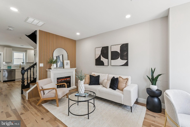 344 Elm St NW, Washington, DC 20001 - living room with light wood finished floors, recessed lighting, baseboards, and a glass covered fireplace