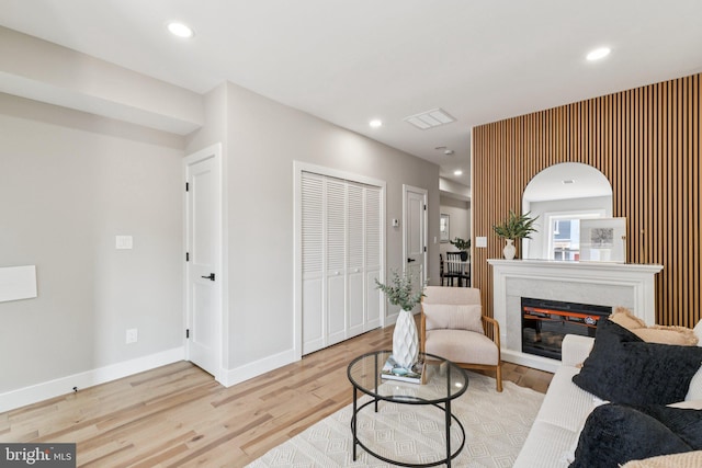 344 Elm St NW, Washington, DC 20001 - living room with light wood-style floors, a glass covered fireplace, baseboards, and recessed lighting