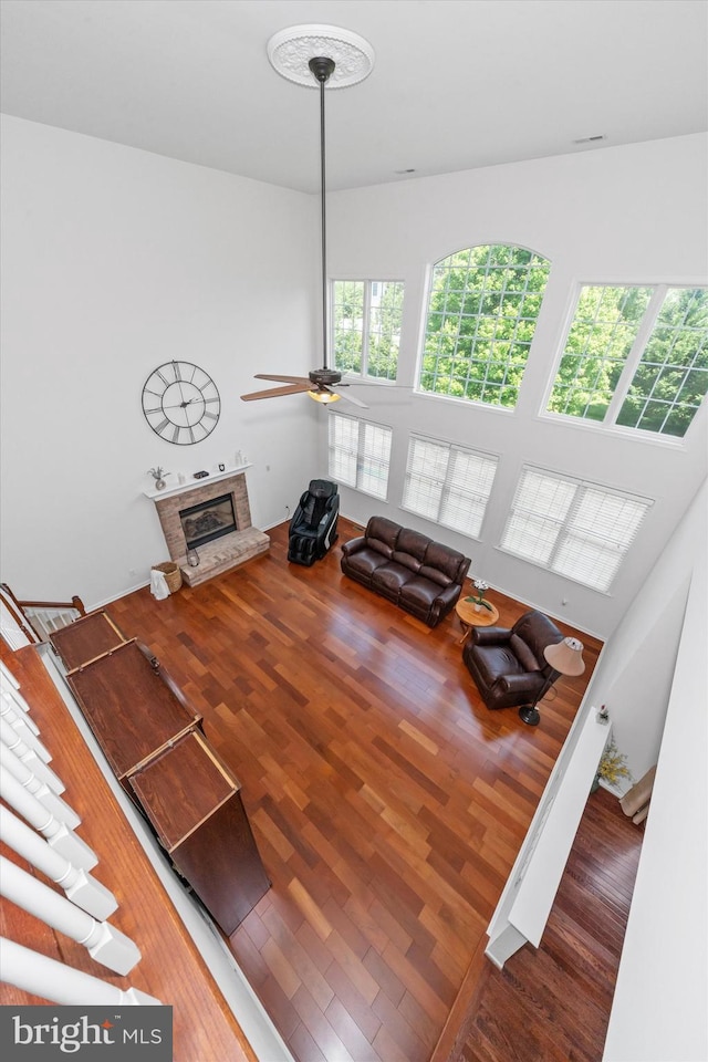 915 Mather Dr, Bear, DE 19701 - living room featuring a ceiling fan, a stone fireplace, and wood finished floors