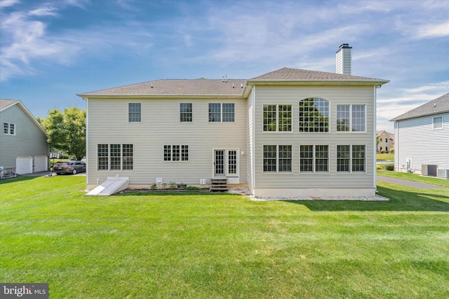 915 Mather Dr, Bear, DE 19701 - back of property featuring a lawn, a chimney, and entry steps