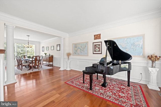 915 Mather Dr, Bear, DE 19701 - living area with ornate columns, wood finished floors, crown molding, a chandelier, and a wainscoted wall