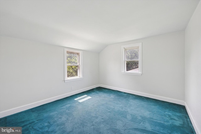 2120 Grand Ave, Morton, PA 19070 - empty room featuring vaulted ceiling, plenty of natural light, baseboards, and dark colored carpet