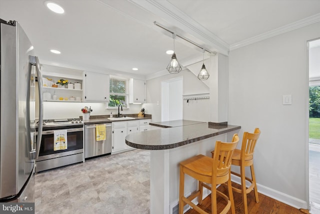 2120 Grand Ave, Morton, PA 19070 - kitchen with appliances with stainless steel finishes, dark countertops, a sink, a peninsula, and white cabinetry