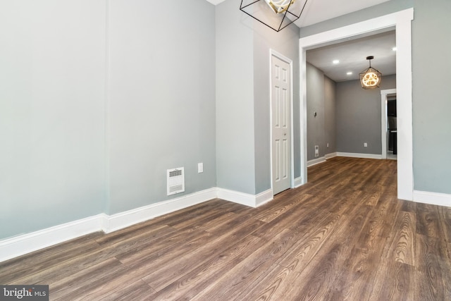 2525 W Lombard St, Baltimore, MD 21223 - spare room with baseboards, wood finished floors, recessed lighting, heating unit, and a chandelier