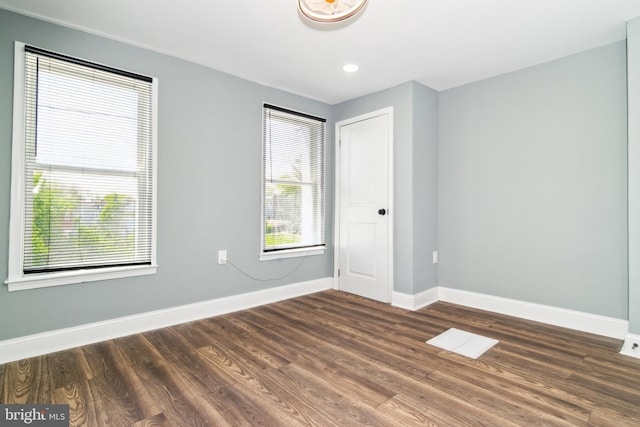2525 W Lombard St, Baltimore, MD 21223 - unfurnished bedroom with baseboards, multiple windows, wood finished floors, and recessed lighting