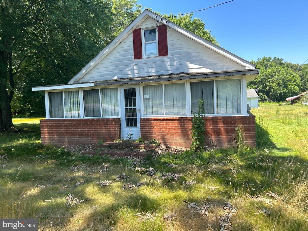22323 Colton Point Rd, Bushwood, MD 20618 - bungalow-style house with brick siding and a sunroom
