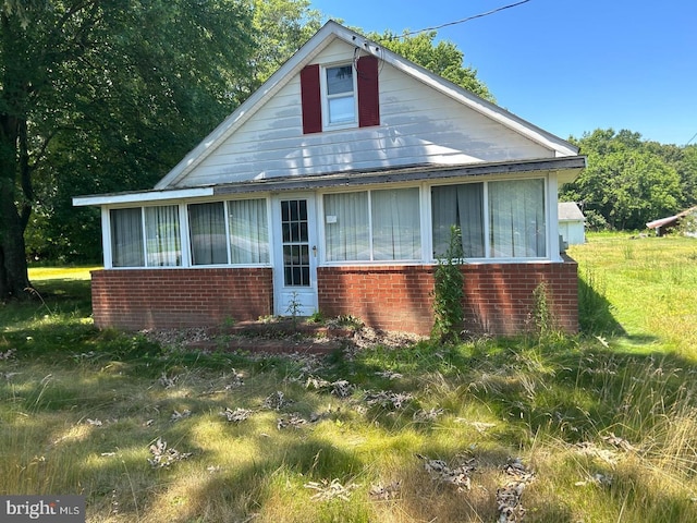 22323 Colton Point Rd, Bushwood, MD 20618 - bungalow-style house with brick siding and a sunroom