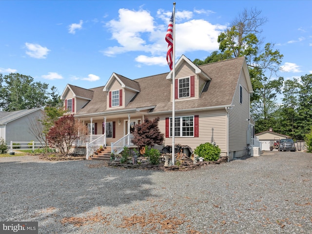 18390 Hudson Rd, Milton, DE 19968 - new england style home with covered porch, a shingled roof, driveway, and an outdoor structure