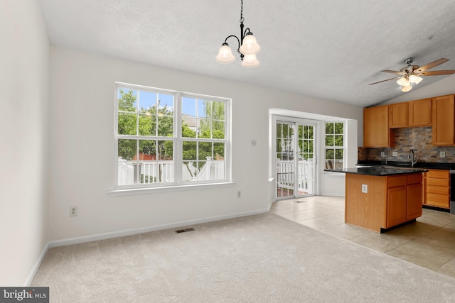 542 June Apple Ct, Abingdon, MD 21009 - kitchen featuring plenty of natural light, backsplash, dark countertops, light carpet, and a textured ceiling