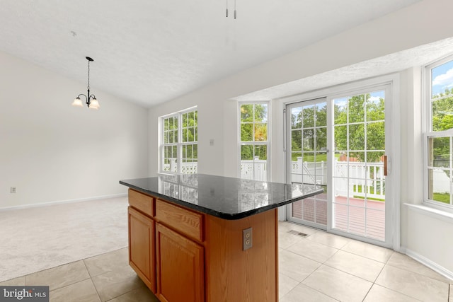 542 June Apple Ct, Abingdon, MD 21009 - kitchen with light carpet, light tile patterned floors, vaulted ceiling, a center island, and baseboards