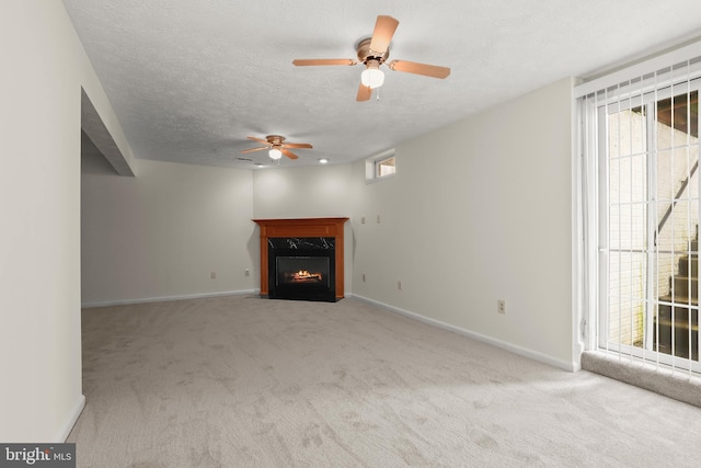 542 June Apple Ct, Abingdon, MD 21009 - unfurnished living room with carpet flooring, a ceiling fan, a high end fireplace, plenty of natural light, and a textured ceiling